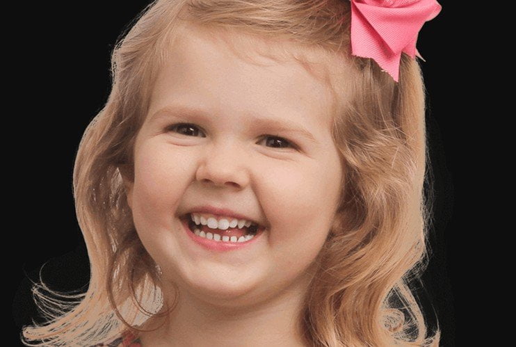 Happy child at a dental check-up with a friendly dentist.